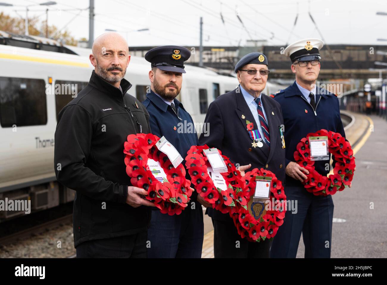 EDITORIAL USE ONLY (Left-right) Thameslink driver, Noel Hughes, Oliver Evans from RAF Henlow, veteran Tony Kemp and Steve King from RAF Henlow at Bedford Station before transporting a poppy wreath to London, marking the rail operator's partnership with The Veterans Charity on the nationwide 'Routes of Remembrance' campaign, which sees poppy wreaths touring the country's railway network to Honour the Fallen. Picture date: Wednesday November 10, 2021. Stock Photo