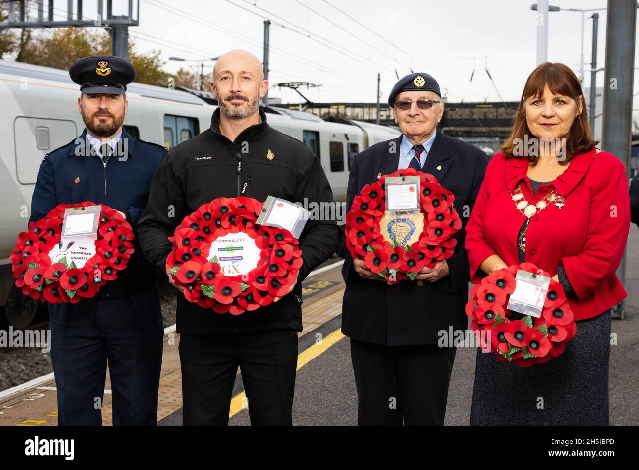 EDITORIAL USE ONLY (Left-right) Oliver Evans from RAF Henlow, Thameslink driver, Noel Hughes, veteran Tony Kemp and Speaker of Bedford Borough Council, Jane Walker at Bedford Station before transporting a poppy wreath to London, marking the rail operator's partnership with The Veterans Charity on the nationwide 'Routes of Remembrance' campaign, which sees poppy wreaths touring the country's railway network to Honour the Fallen. Picture date: Wednesday November 10, 2021. Stock Photo