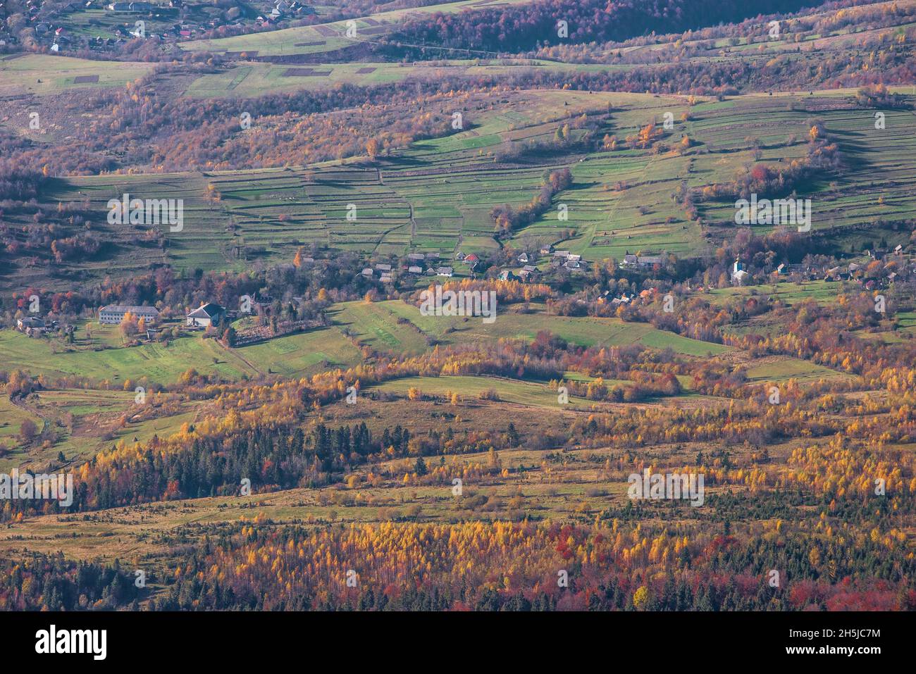 View of hills of Water Dividing ridge covered in red, orange and yellow ...