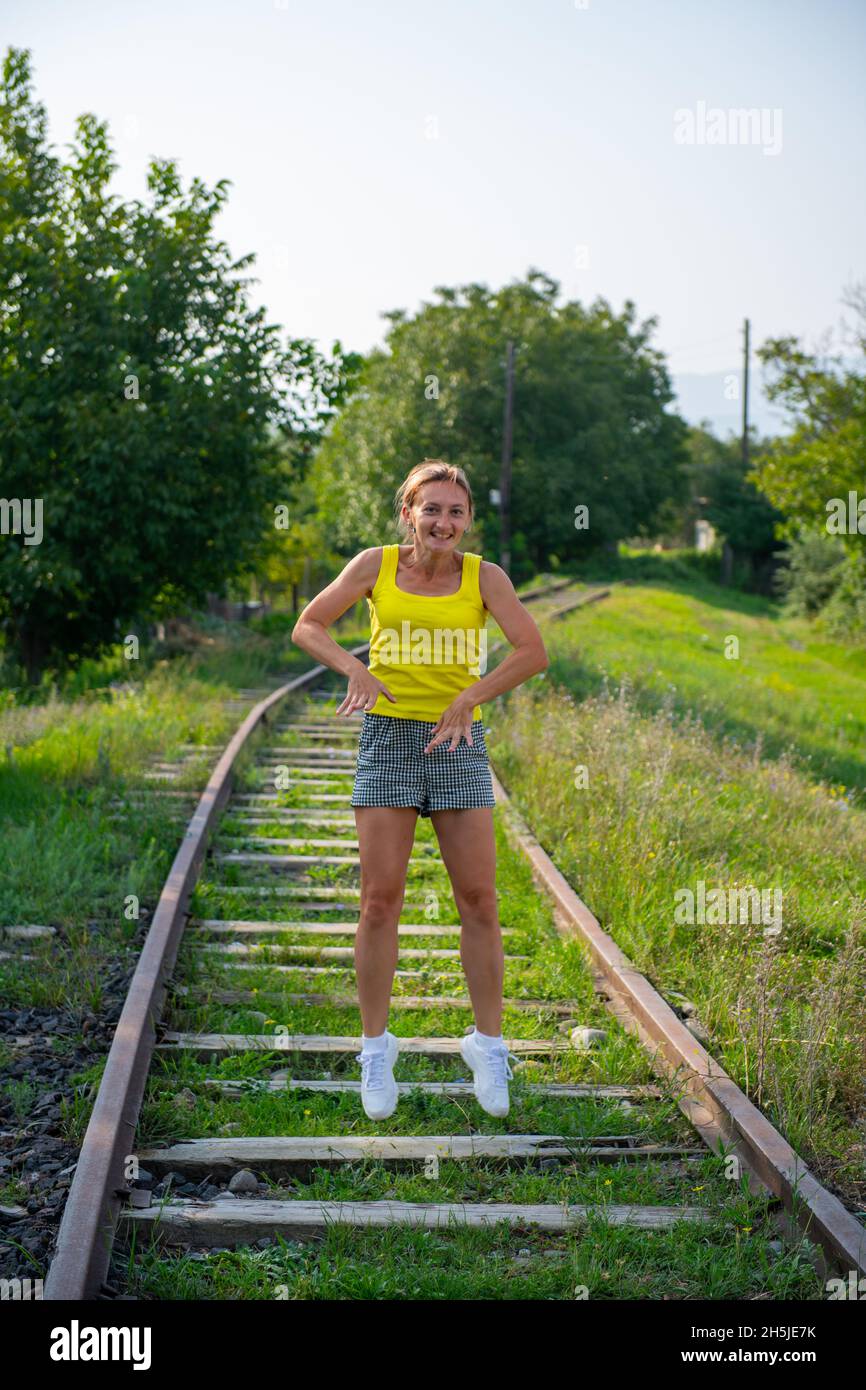 crazy girl jumping on the railroad tracks Stock Photo Alamy