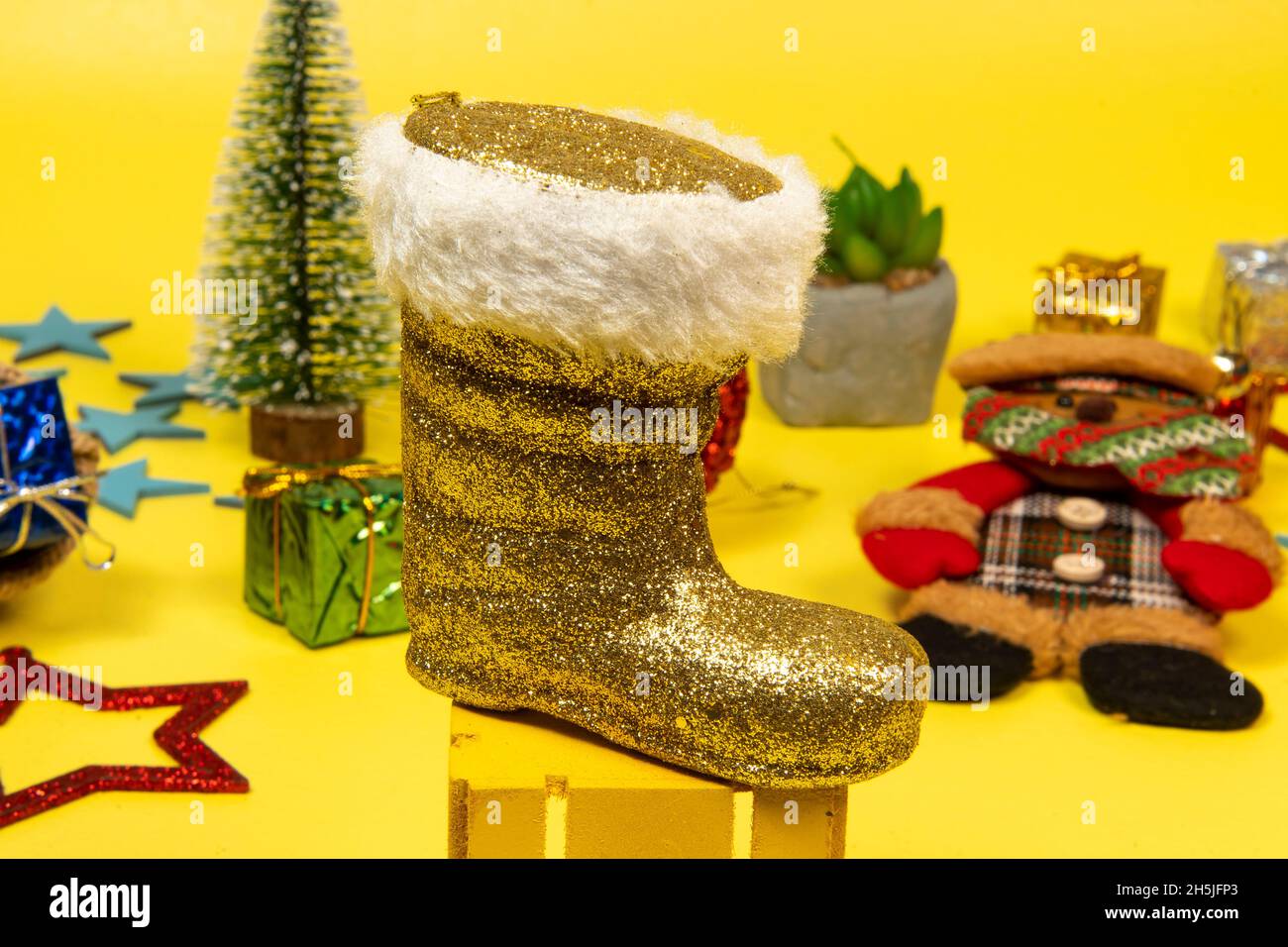 Ornament Santa Claus boot on yellow background with christmas elements