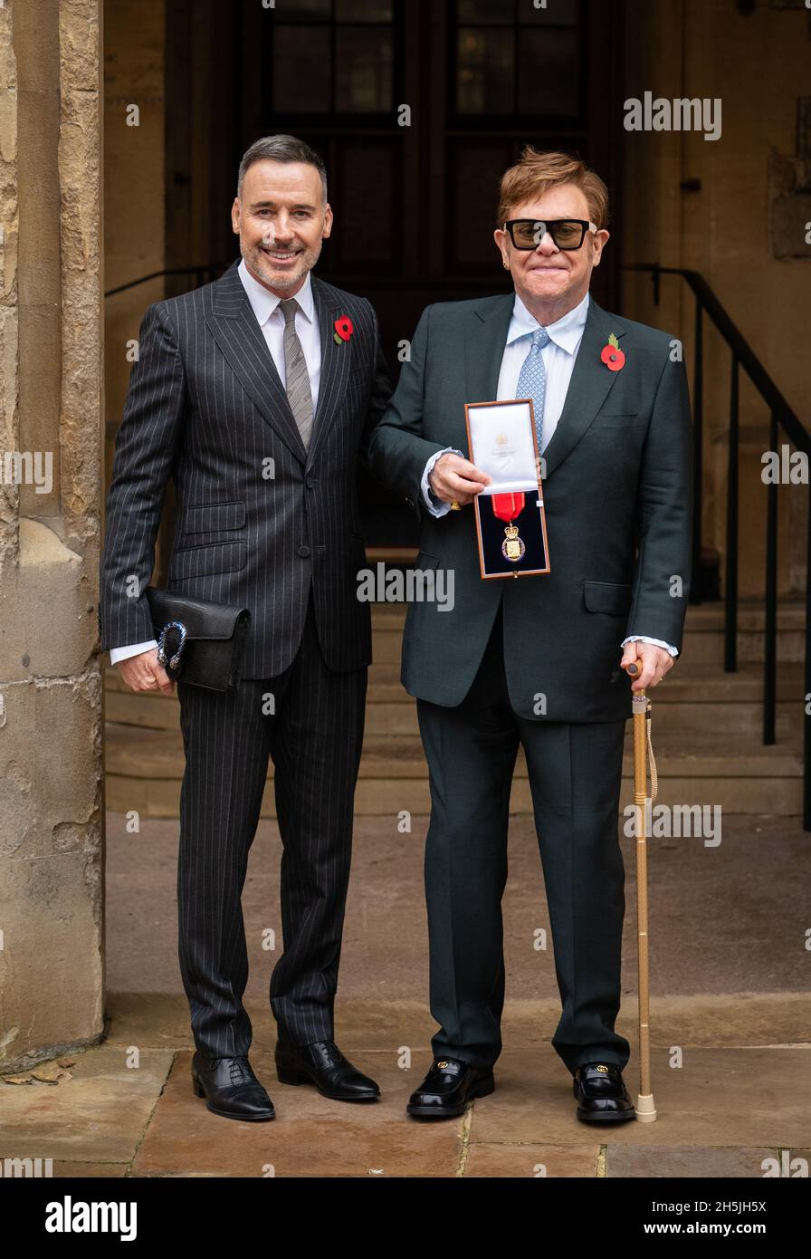 Sir Elton John with his husband David Furnish (left) after being made a