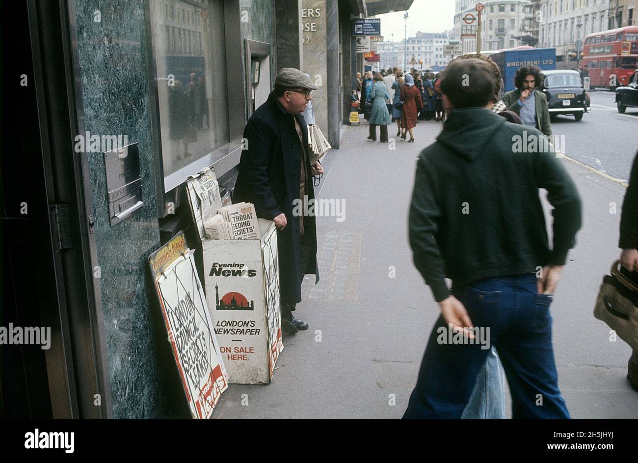 London 1982. A street view of a London street with a newspaper salesman for the Evenening News. Credit Roland Palm. Stock Photo