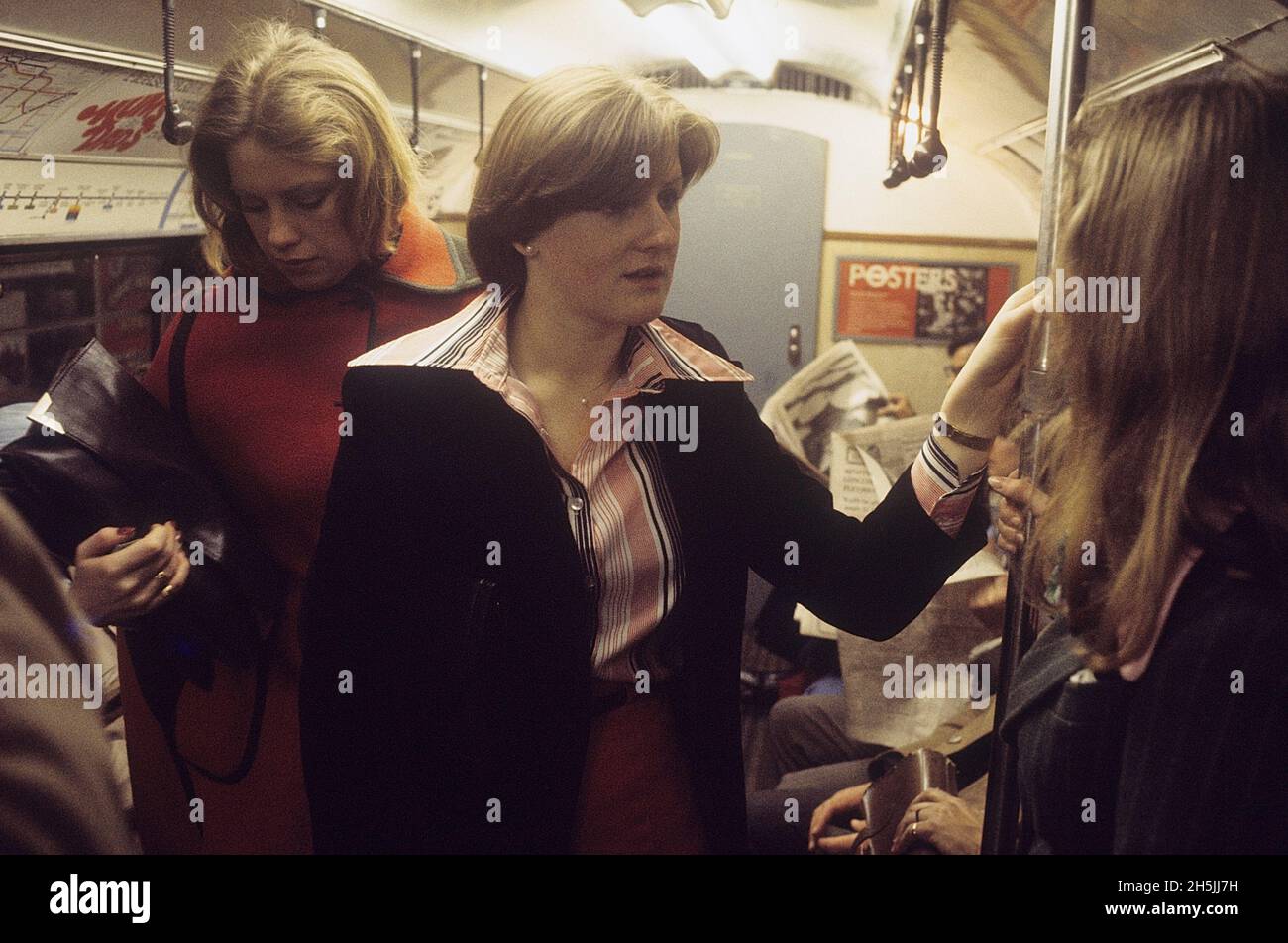 London 1982. Interior of a subwaytrain in London with people sitting and standing on the train. Credit Roland Palm. Stock Photo