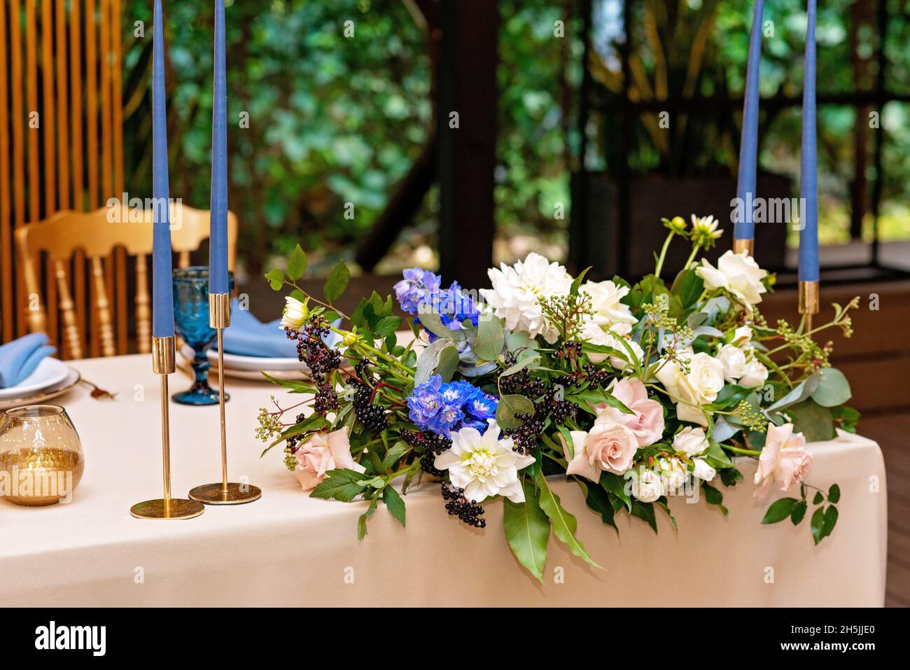 Wedding presidium, banquet table for newlyweds with flowers, greenery ...