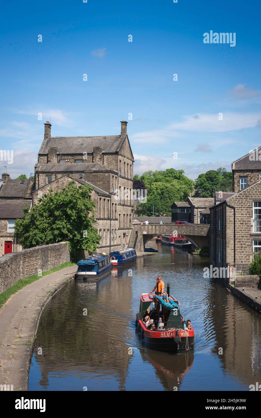 Leeds Liverpool Canal, view in summer of a narrow boat cruising the Leeds And Liverpool Canal approaching the North Yorkshire town of Skipton Stock Photo