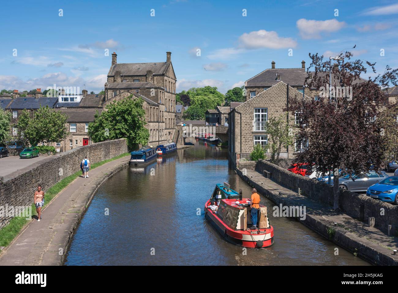 Leeds Liverpool Canal, view in summer of a narrow boat cruising the Leeds And Liverpool Canal approaching the North Yorkshire town of Skipton Stock Photo