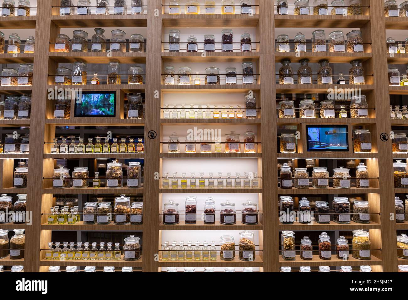 Dubai, UAE, 27.10.21. Old wooden pharmacy cabinet with jars, vials and flasks containing dried herbs, natural medicine concept. Stock Photo