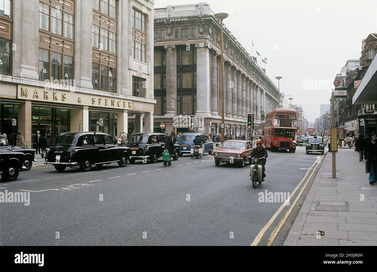 London 1982. A street view of Oxford street with the traffic passing, buses and taxis. Credit Roland Palm. Stock Photo