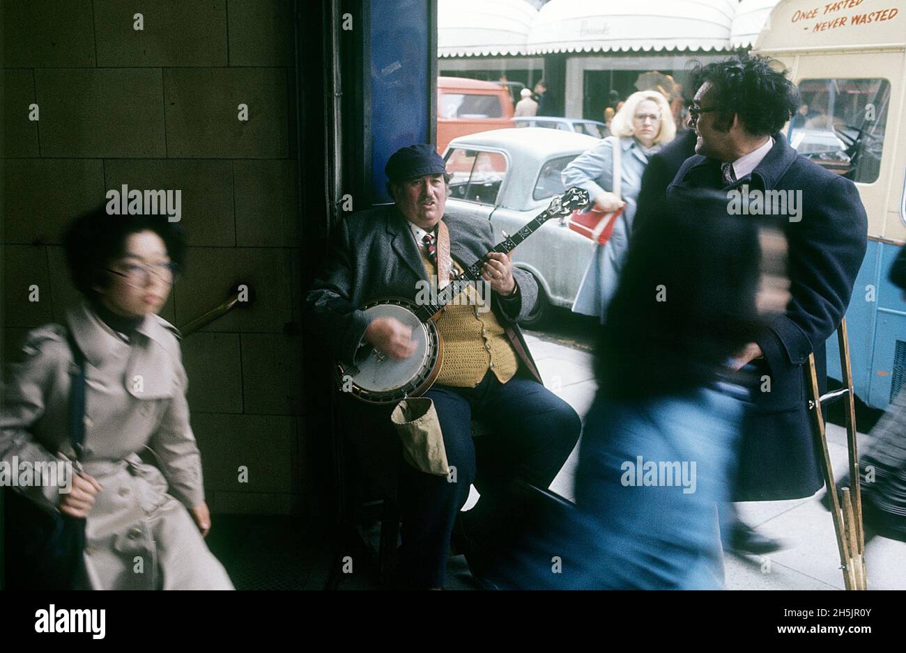 London 1982. A London street view and a man is playing the for money. Credit Roland Palm. Stock Photo
