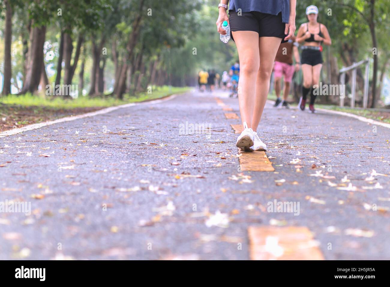 Asian woman power walking hi-res stock photography and images - Alamy