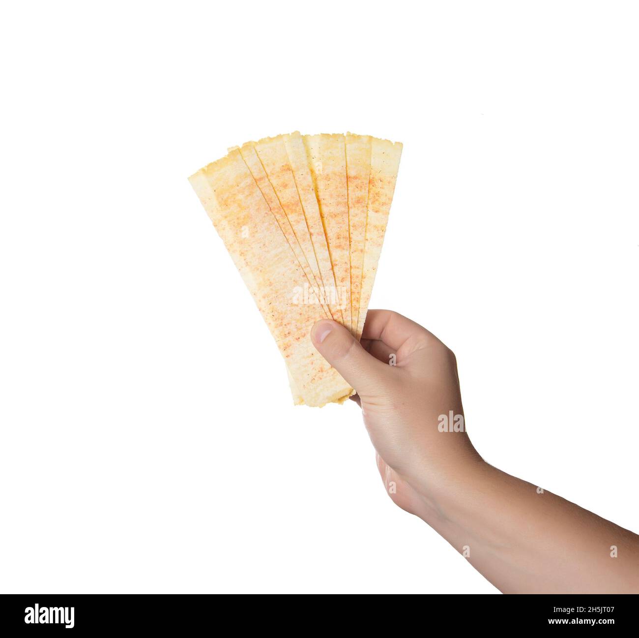 Yellow oblong chips in a man's hand on a white background, isolate.  Close-up Stock Photo - Alamy