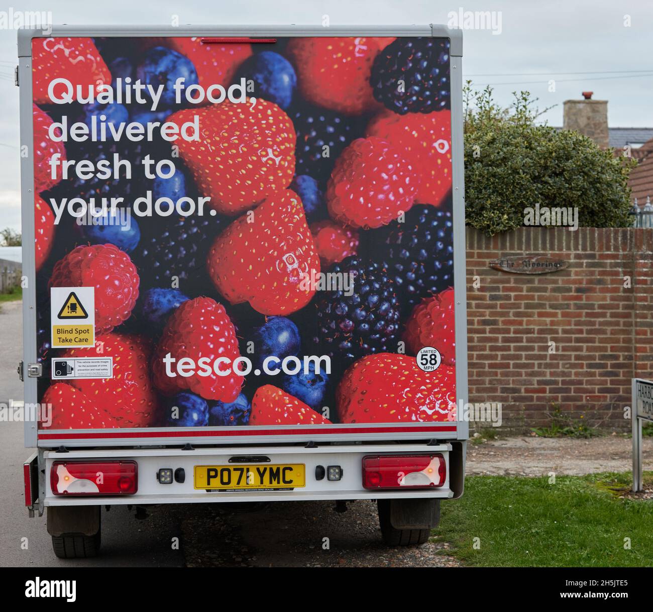 A tesco delivery van seen parked on the side of a road. Stock Photo