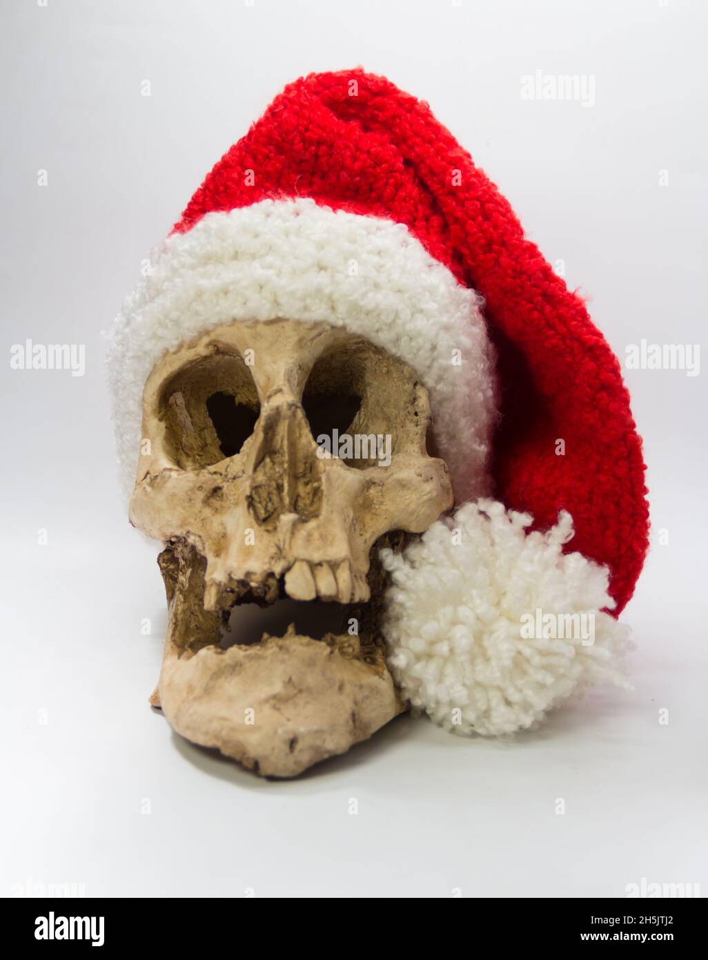 human skull with elf cap isolated on black background Stock Photo