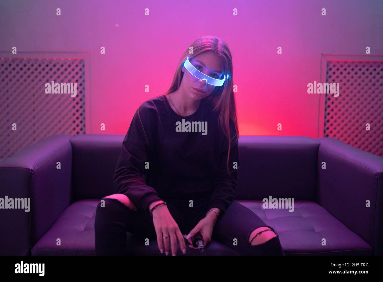 Futuristic neon glasses glow in the eyes of a young woman Stock Photo ...