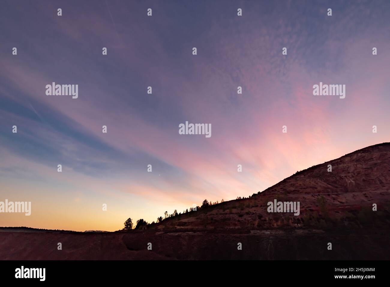 Landscape of sunset in the mountains with cloudy sky Stock Photo - Alamy