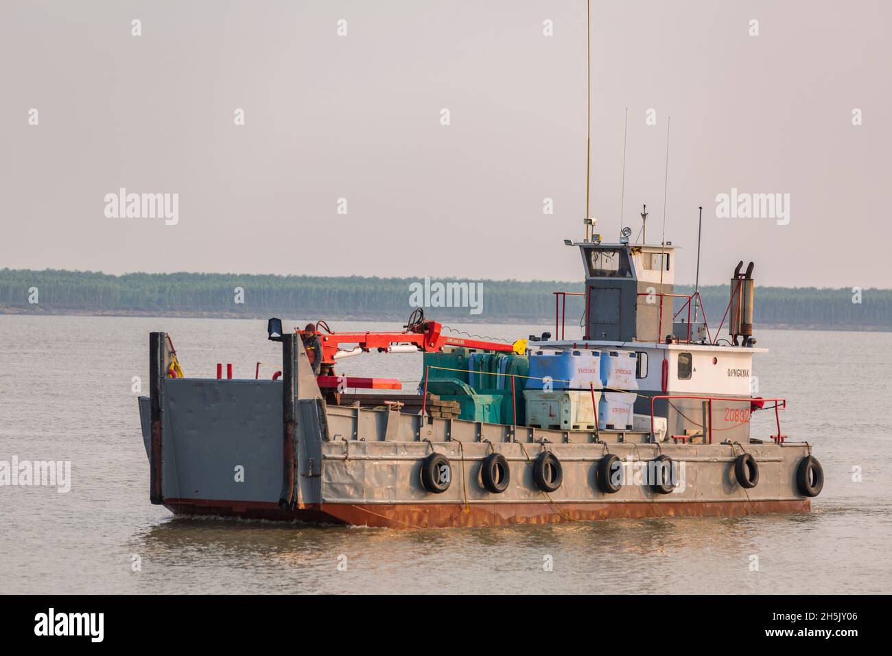 Floating tender carries totes full of salmon for processing at the Kwik