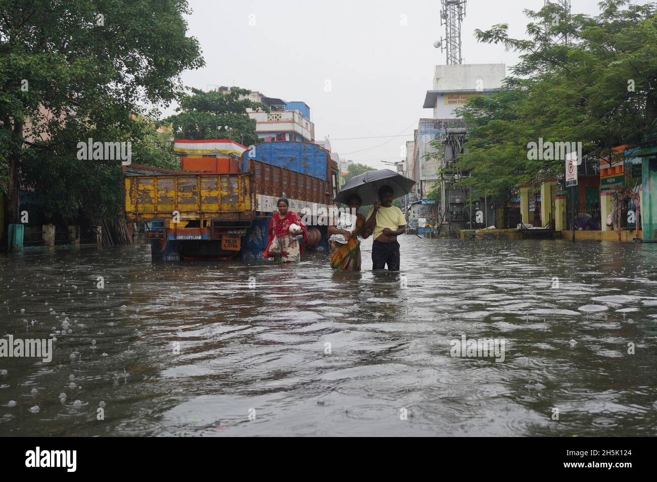 Chennai, Tamil Nadu, India. 10th Nov, 2021. Residents walk through a