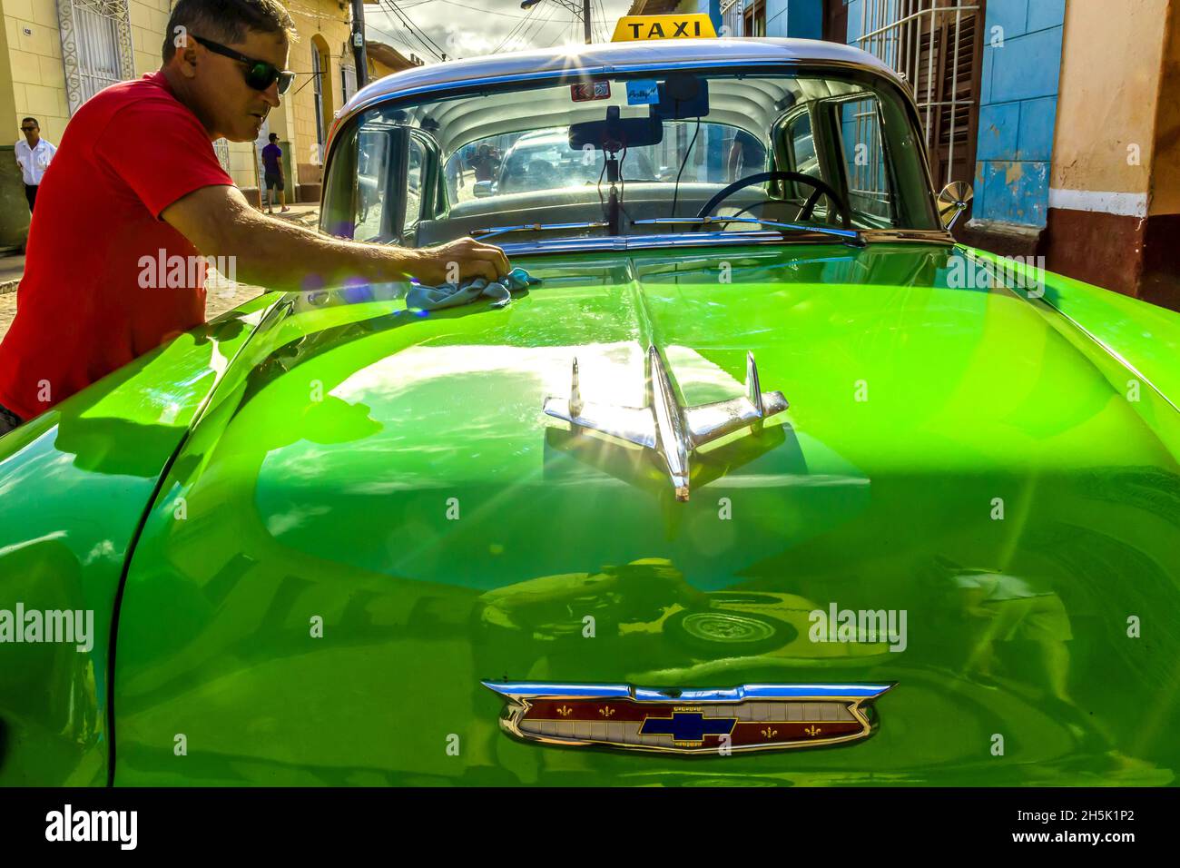Driver waxing his classic American Car Stock Photo Alamy