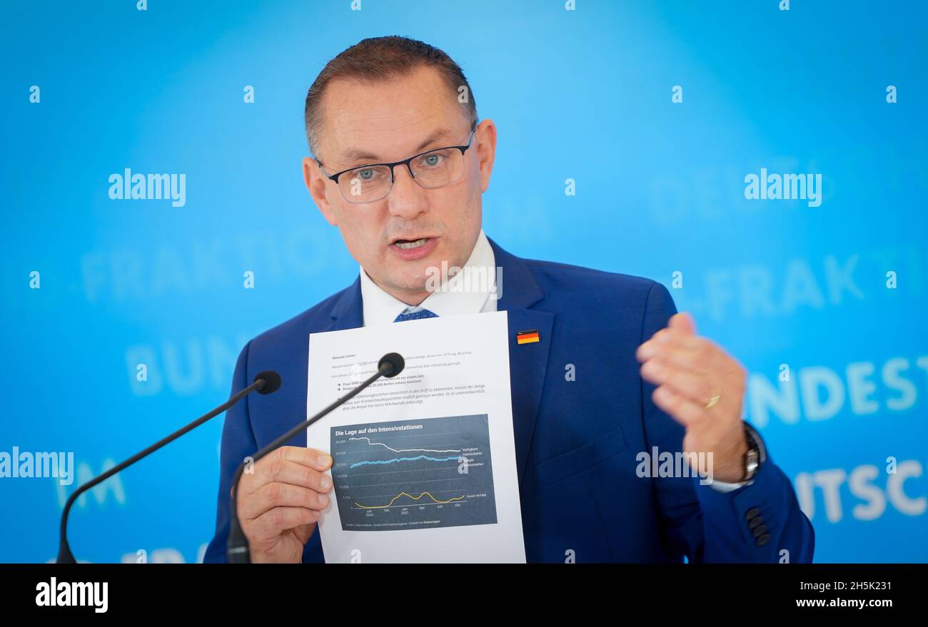 Berlin, Germany. 10th Nov, 2021. Tino Chrupalla, AfD federal chairman and AfD parliamentary group leader, gives a press conference at the beginning of his party's parliamentary group meeting in the Bundestag, showing a piece of paper with the occupancy of intensive care units with Covd-19 patients. Credit: Kay Nietfeld/dpa/Alamy Live News Stock Photo