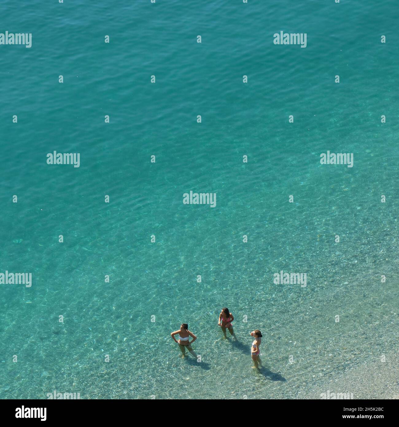 Three women in bikinis in the sea. Almuñecar, Costa Tropical, Granada Province, Andalusia, southern Spain. Stock Photo