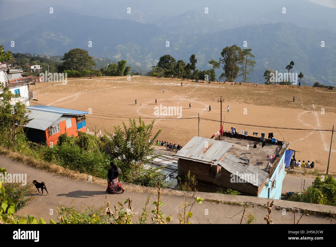 A soccer field cut right into the side of the mountains entertains Ilam youth. Stock Photo