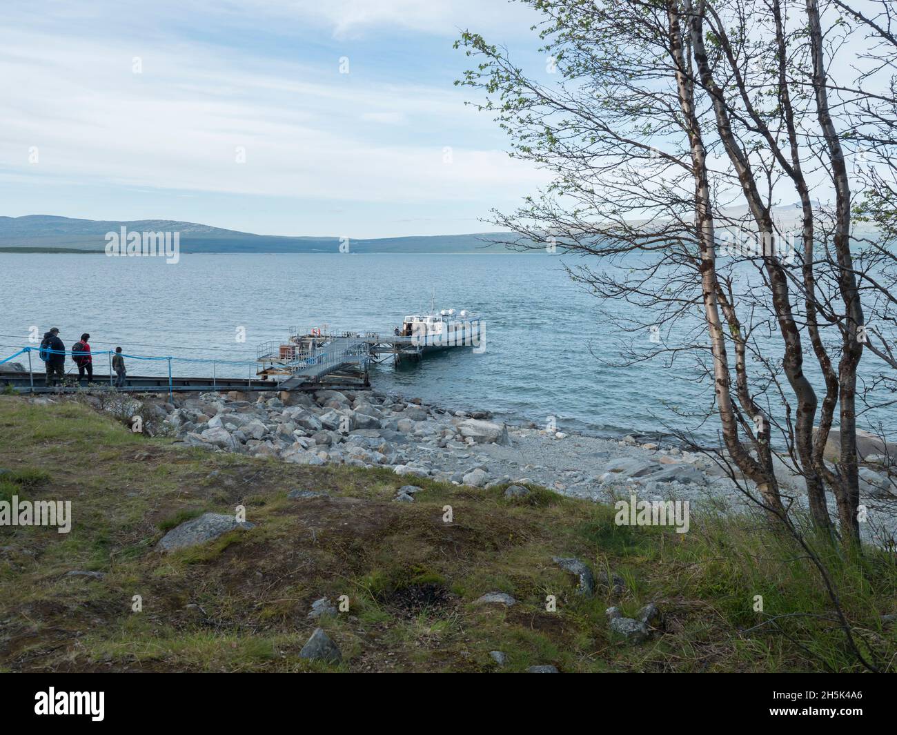 Ritsem, Norrbotten, Sweden, Agust 7, 2021: Group of hiker people at pier, get in to Ferry boat ship MS Storlule at Anonjalmme, start of Stock Photo