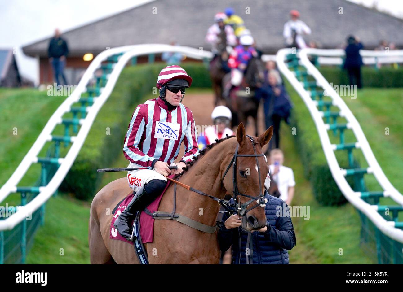 Giovanni Royale ridden by jockey Nick Scholfield leads the field out ahead of the Racing Welfare Supporting Racing's Workforce Novices' Hurdle at Bangor-on-Dee racecourse. Picture date: Wednesday November 10, 2021. Stock Photo