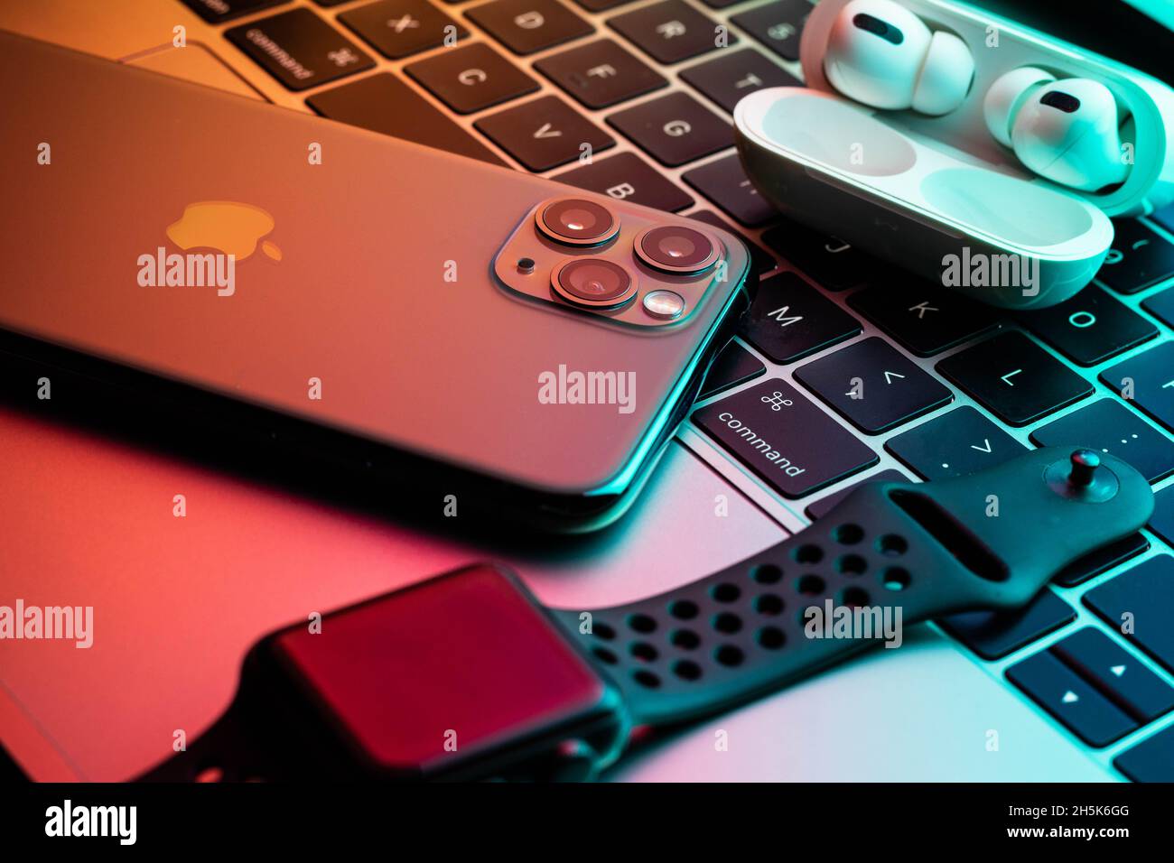 iPhone 11 Pro with AirPods Pro and Apple Watch with a Macbook in the  background Stock Photo - Alamy