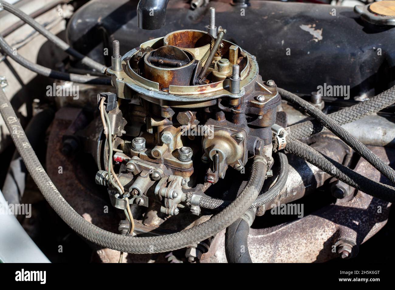 Disassembled carburetor on old engine without top and air