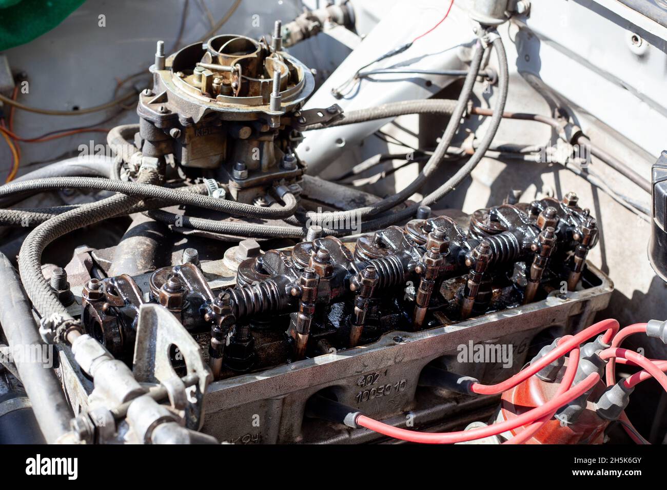 Disassembled carburetor motor. Cylinder head with rocker shaft