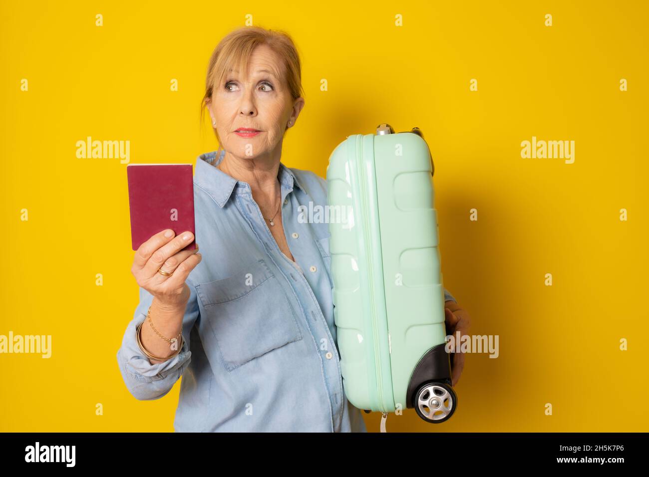 Mature woman passport suitcase hi-res stock photography and images - Alamy