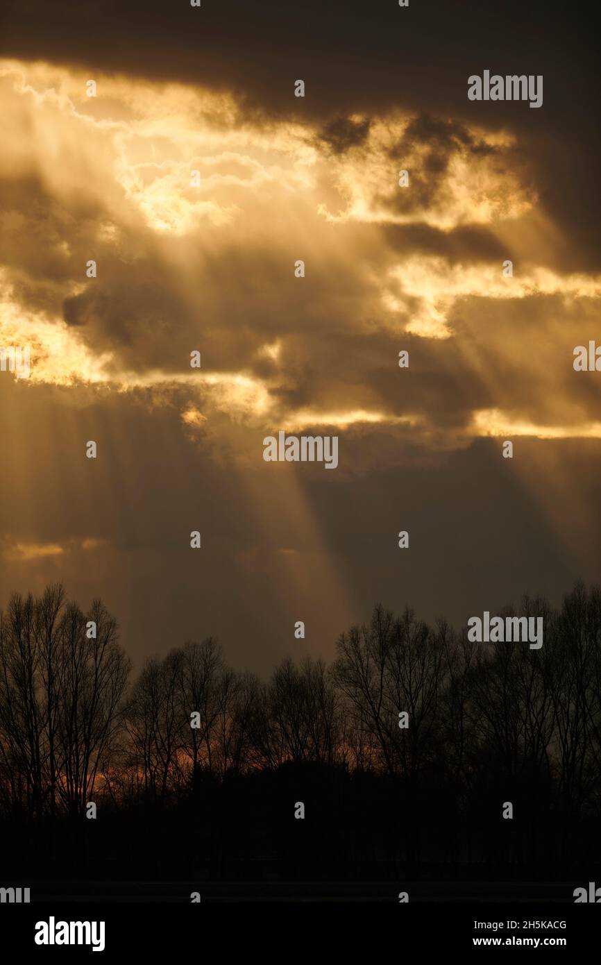 Rays of sunshine coming through dark clouds; Bavaria, Germany Stock Photo