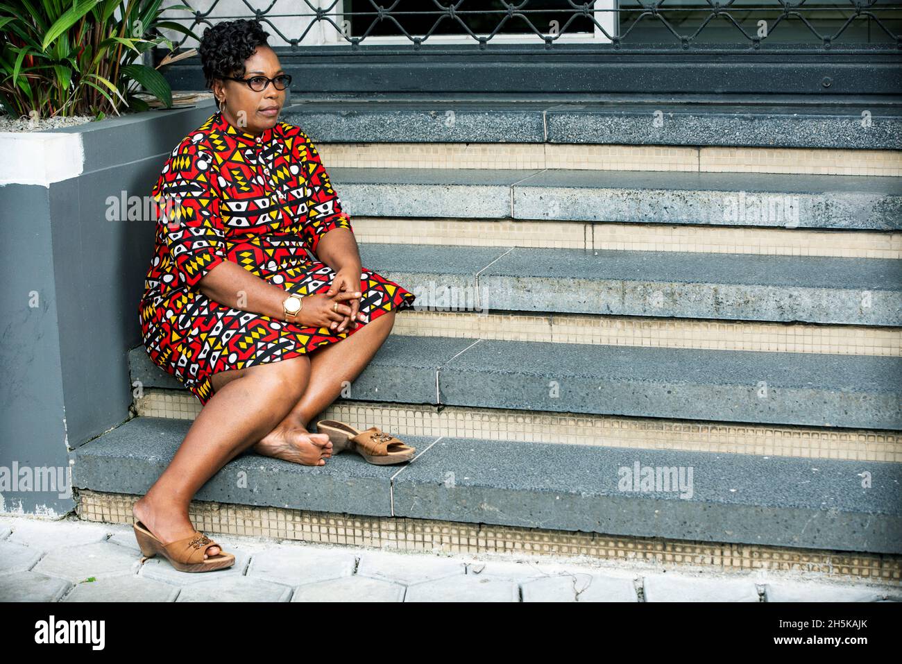 African woman sitting alone side view hi-res stock photography and ...