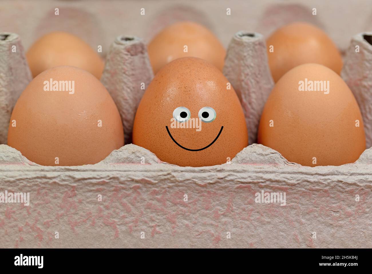 Eggs in the packaging with a funny face Stock Photo