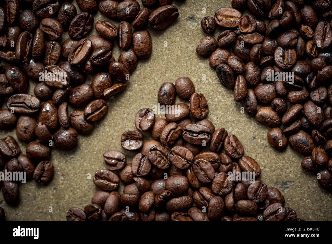 Roasted coffee beans on a grey surface; Studio Stock Photo - Alamy