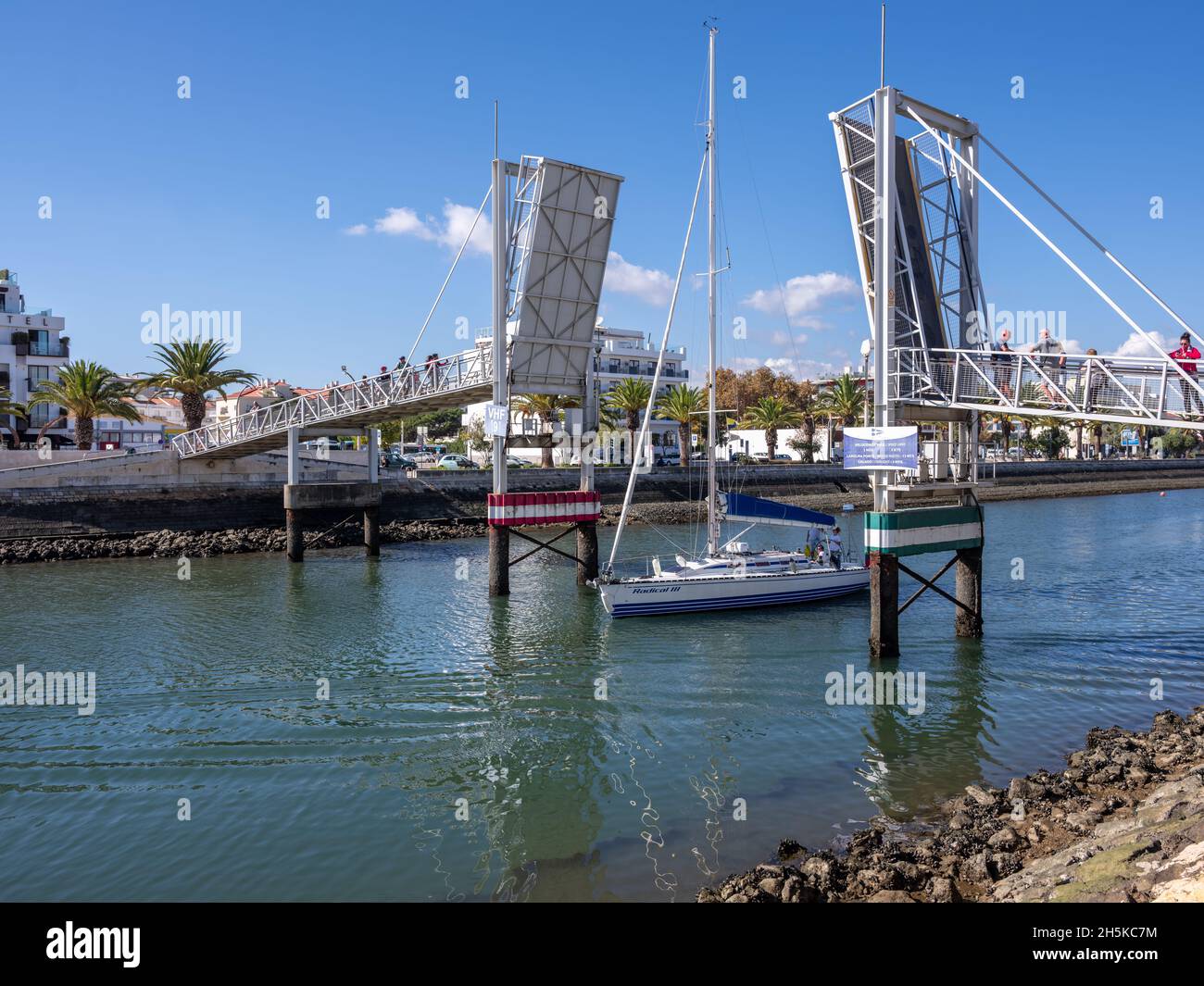 Lagos, Algarve, Portugal - November 10 2021: Yacht passing through the open bascule footbridge from Marina De Lagos Stock Photo