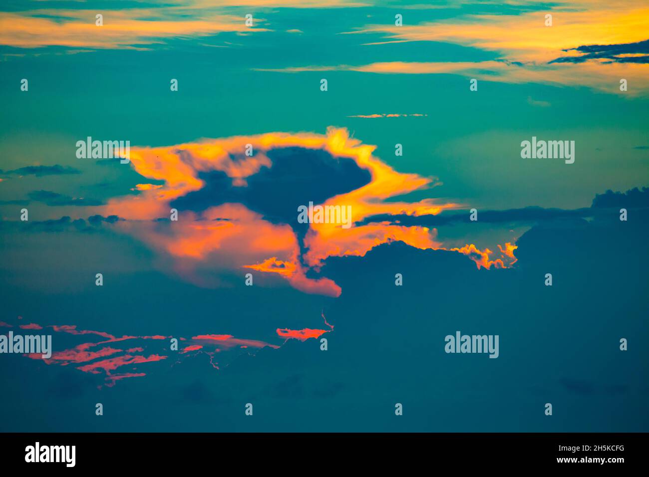 Sunset cloud formation at dusk over the Solomon Sea off Morobe Province, Papua New Guinea; Morobe Province, Papua New Guinea Stock Photo