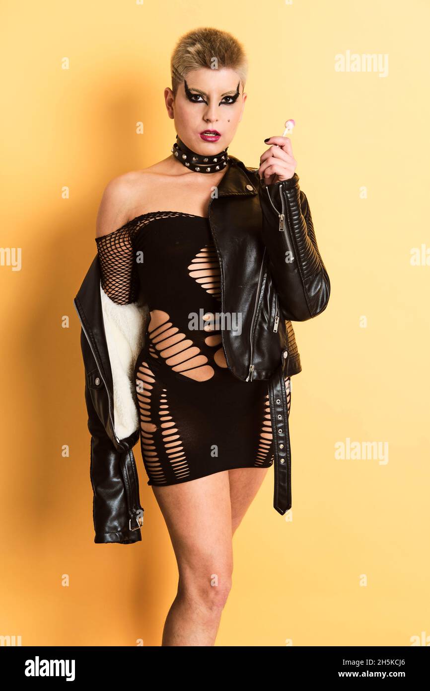 Portrait of a short hair blonde rock girl wearing a leather jacket and a dress with holes Stock Photo