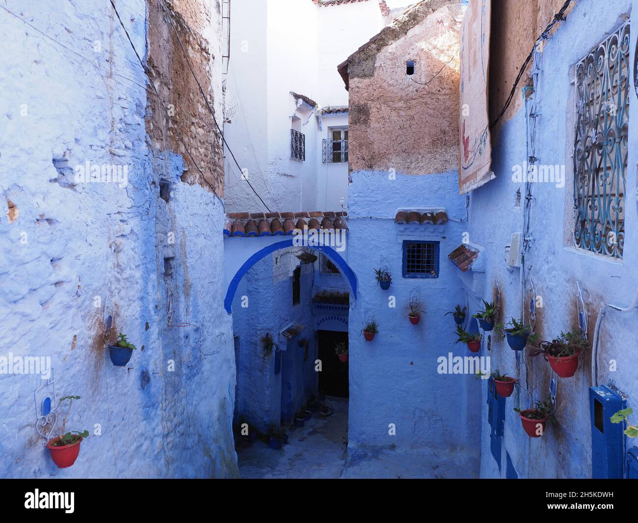 Blue walls of moroccan alley in african Chefchaouen city in Morocco in 2019 warm sunny spring day. Stock Photo