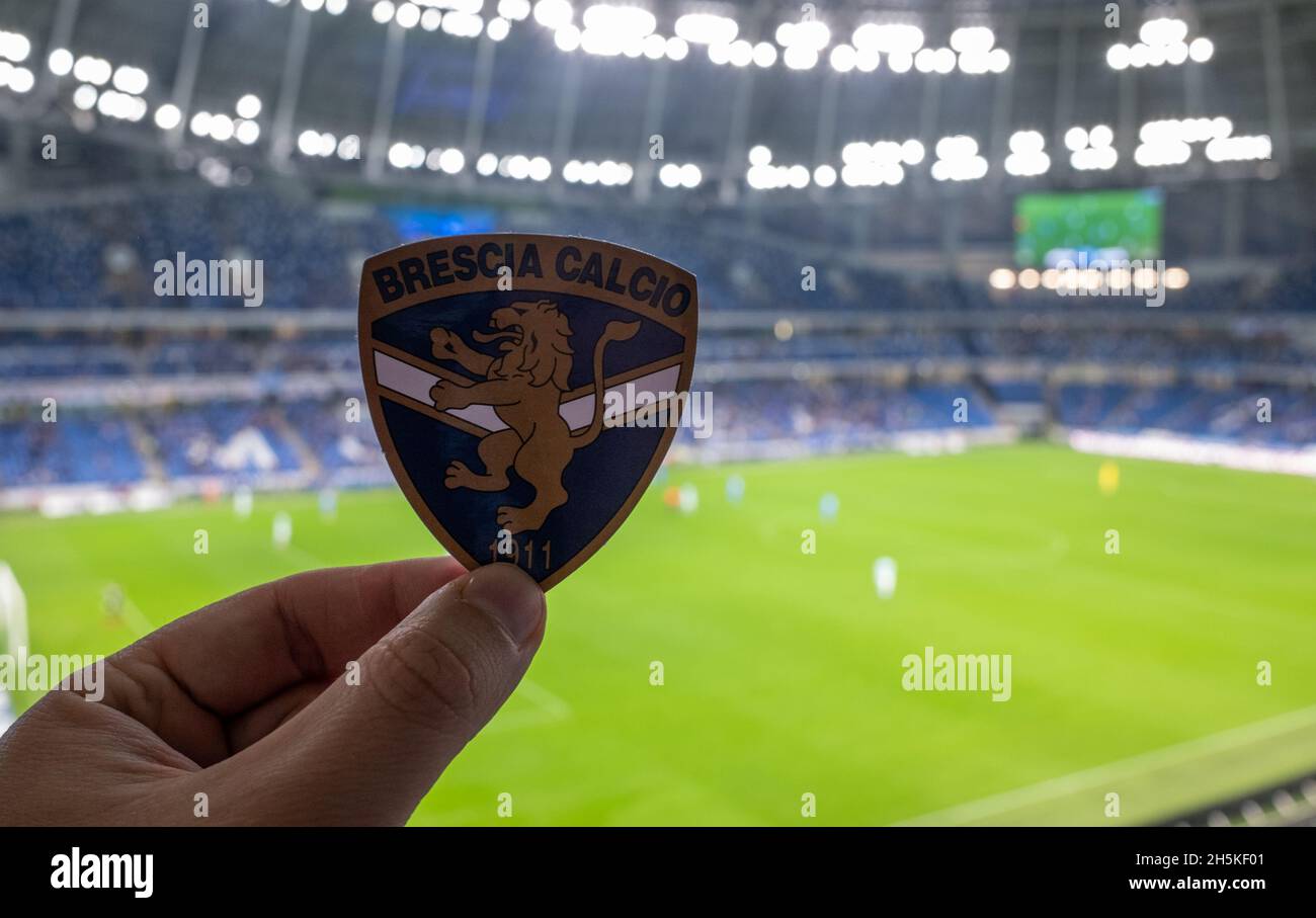 September 12, 2021, Brescia, Italy. The emblem of the football club Brescia Calcio against the background of a modern stadium. Stock Photo