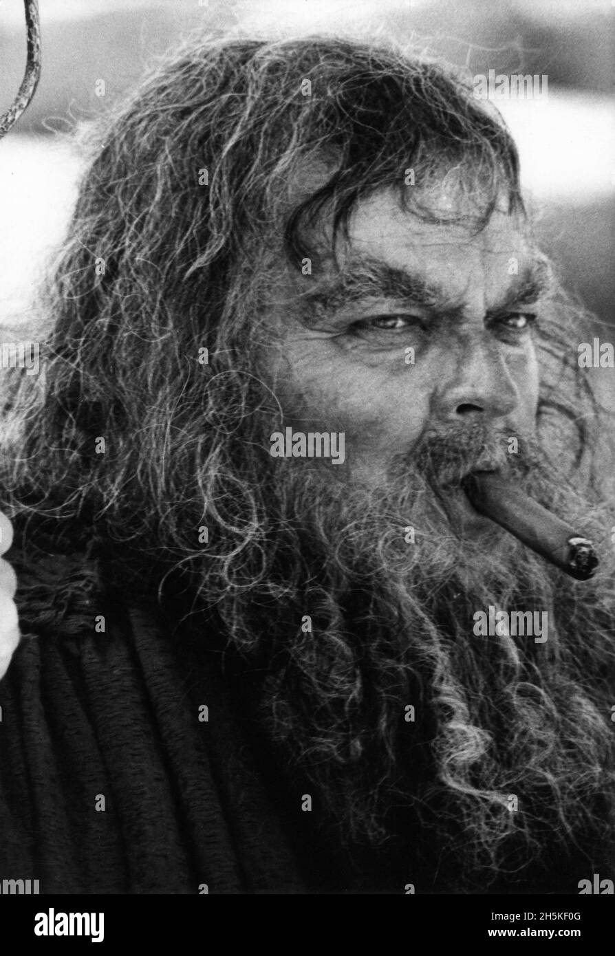 ORSON WELLES on set candid smoking cigar in costume as Tireseas during