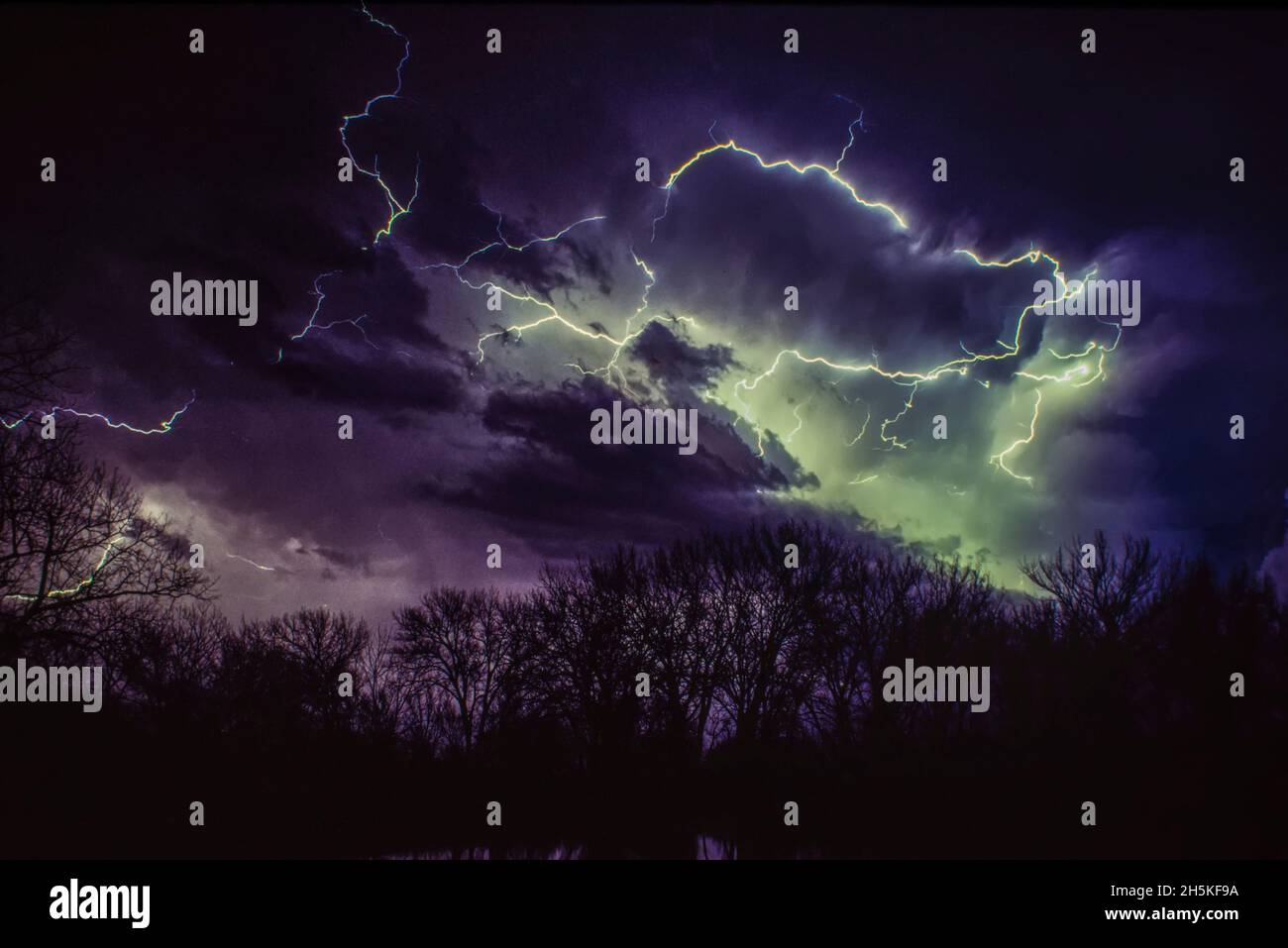 Lightning bolts illuminating a moody night sky; Nebraska, United States of America Stock Photo