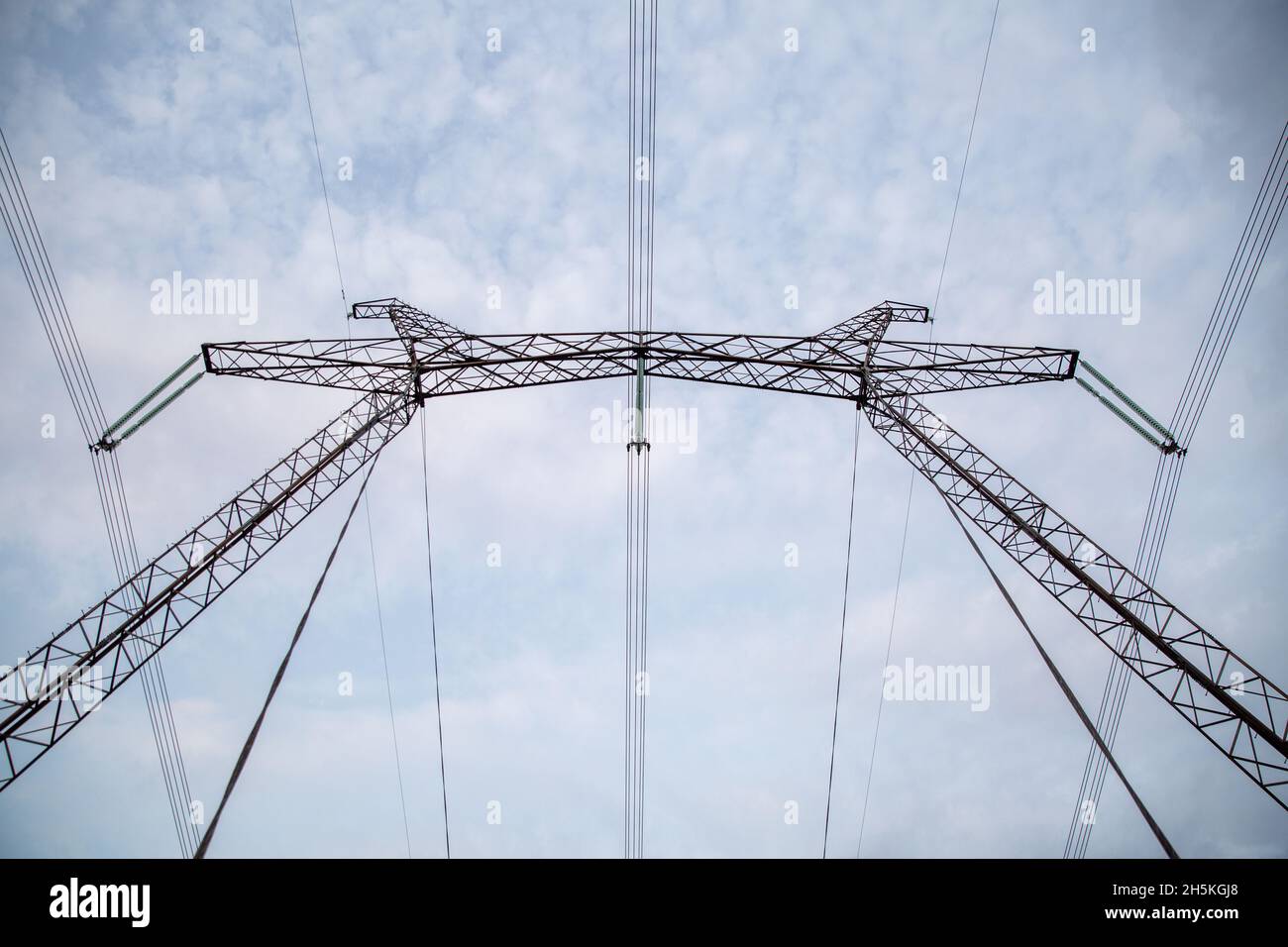 Power transmission lines against a blue sky. Stock Photo