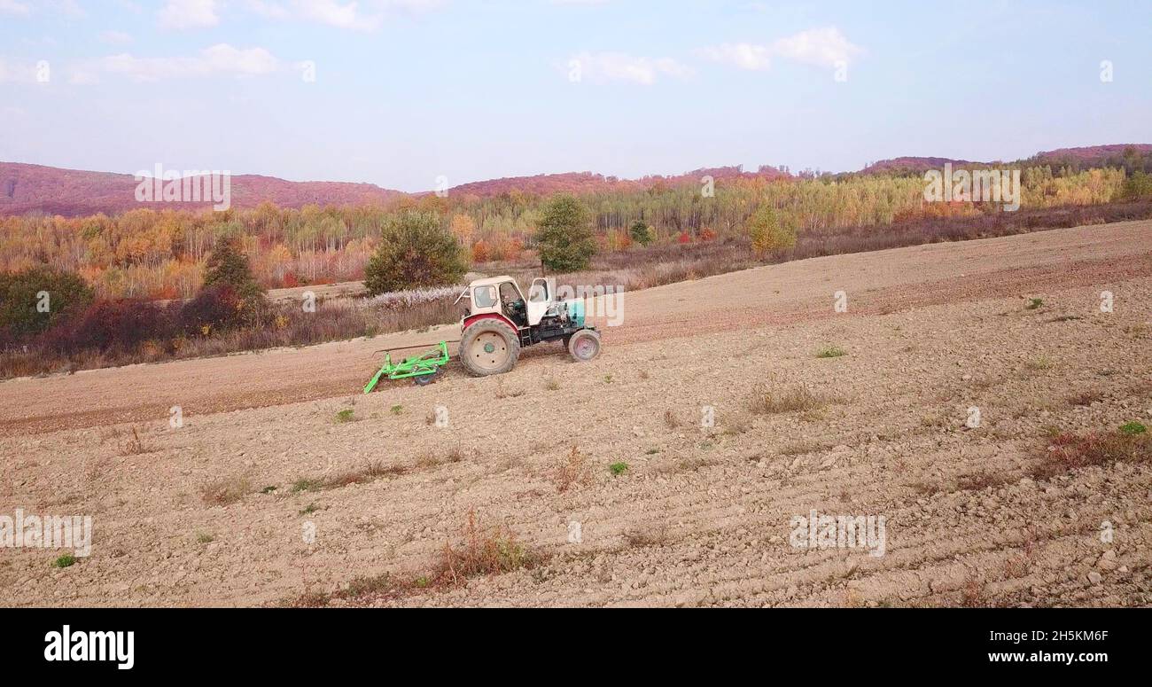 A photo of a soviet tractor in a field Stock Photo