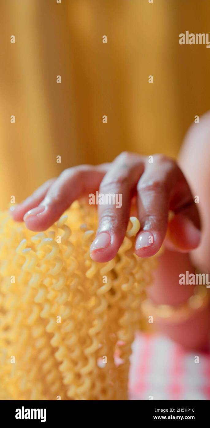 A woman is touching pasta Stock Photo