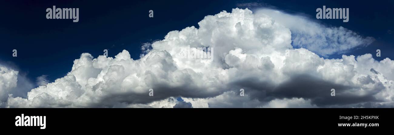 Panorama of dramatic storm clouds with blue sky in the background; Calgary, Alberta, Canada Stock Photo