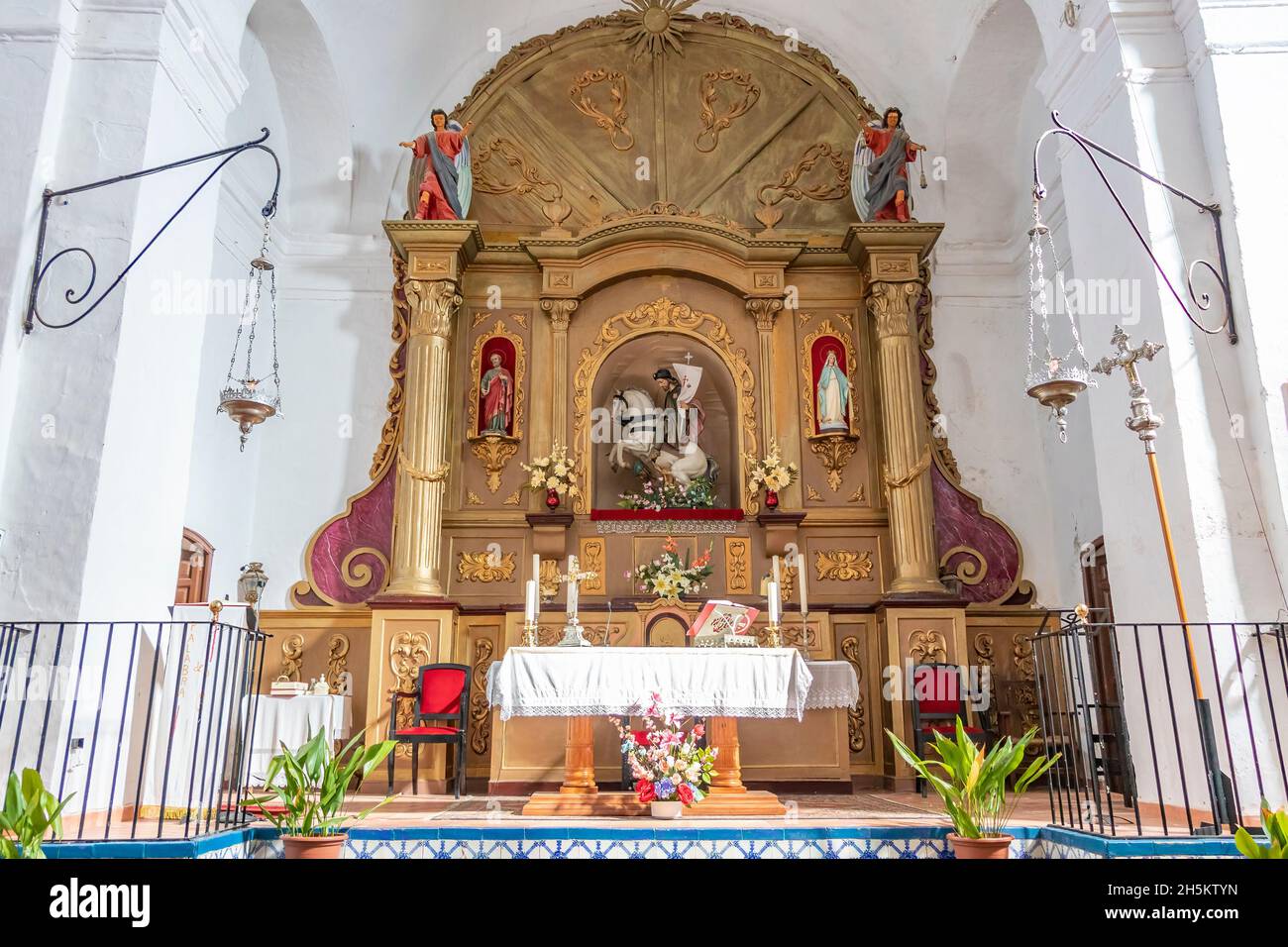 Huelva, Spain - November 5, 2021:  Main altar and altarpiece of The church of Santiago el Mayor, with Santiago Matamoros, in Castaño del Robledo, Sier Stock Photo