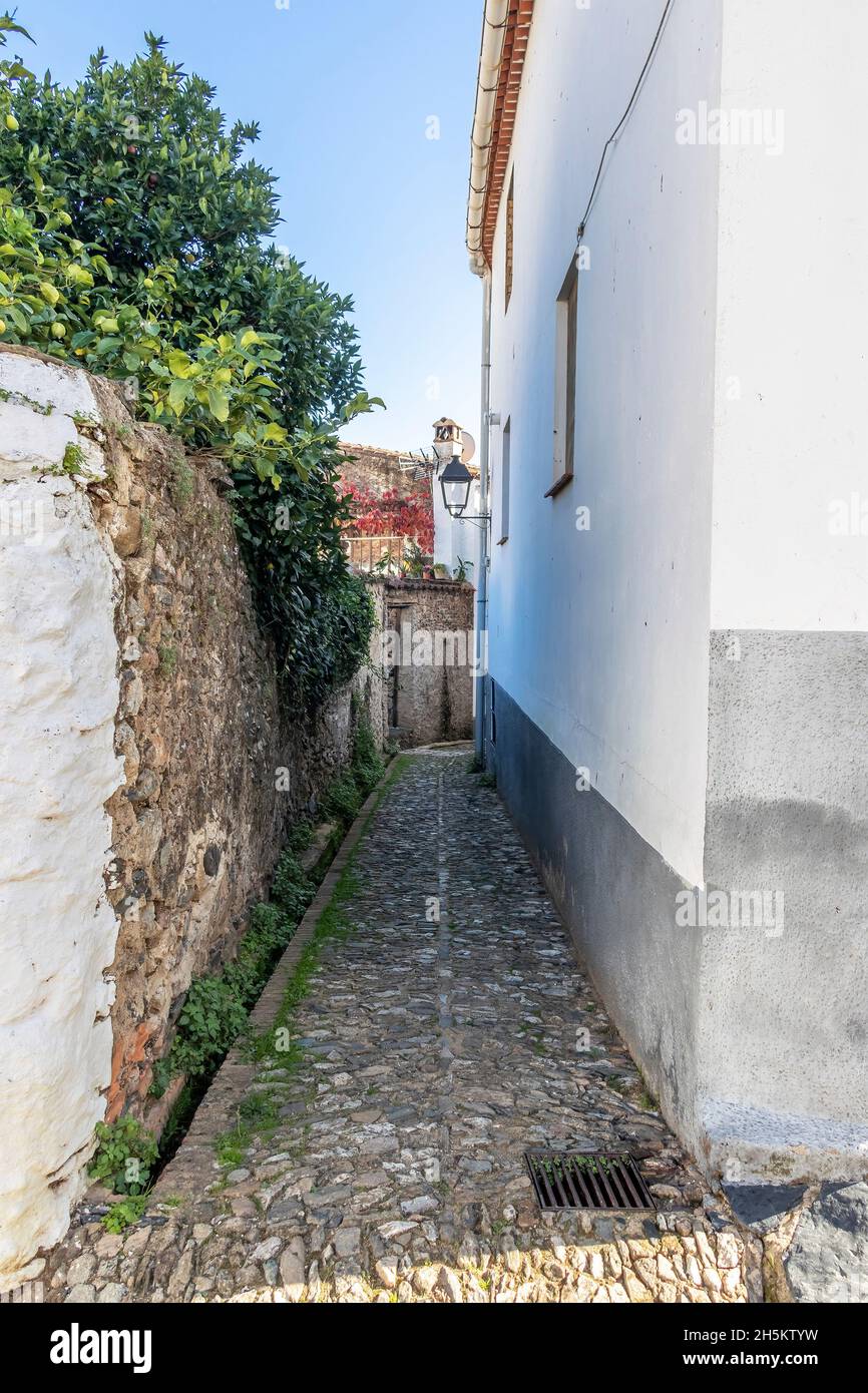Narrow street in the village of Linares de la Sierra, Sierra de Aracena, Huelva mountains Stock Photo