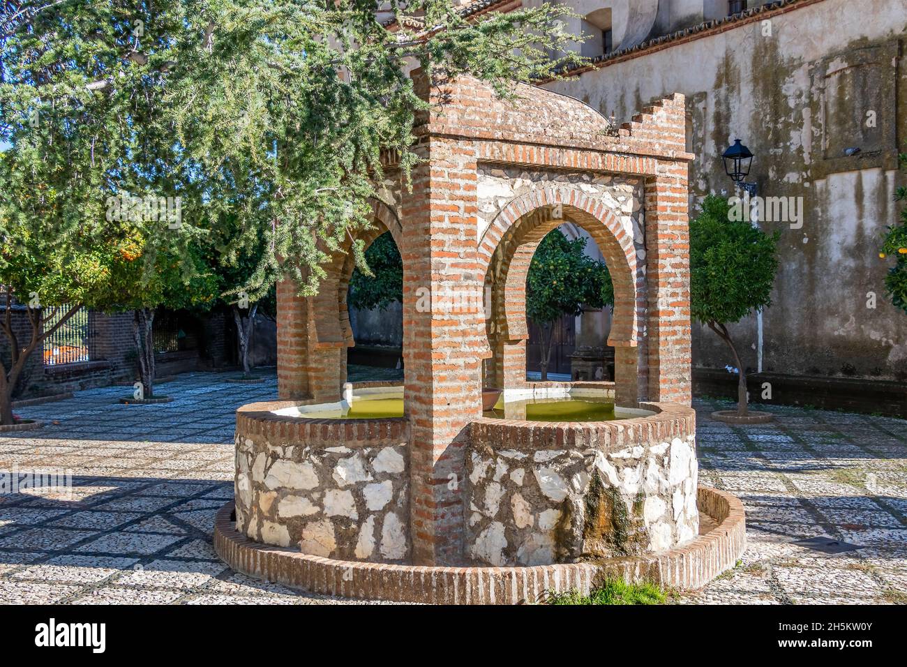 Old fountain in the church square in the village of Linares de la Sierra, Sierra de Aracena, Huelva mountains Stock Photo